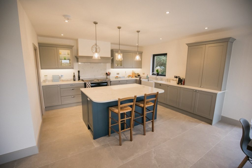 renovated kitchen with blue island and grey cupboards