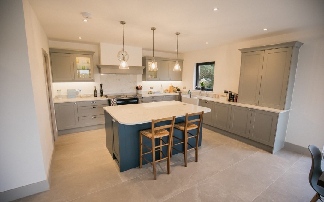 renovated kitchen with blue island and grey cupboards